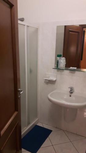 a bathroom with a sink and a shower with a mirror at Albergo Armida in Castenedolo