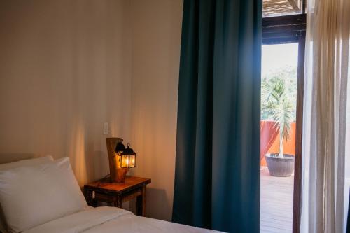 a bedroom with a bed and a window with a view at Ocean & Lighthouse view apartment in Playa Venao