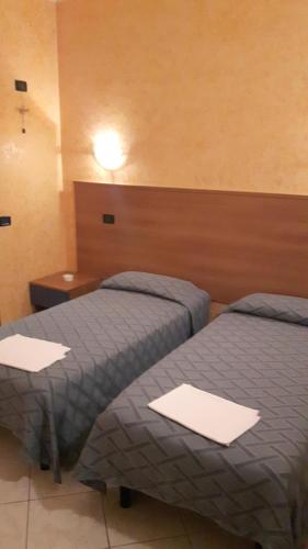 A bed or beds in a room at Albergo Armida