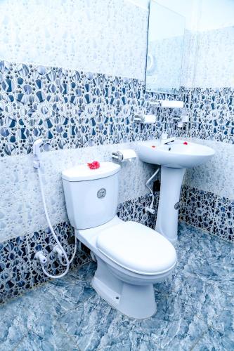 a bathroom with a toilet and a sink at Crescent Sea Resort in Nilaveli