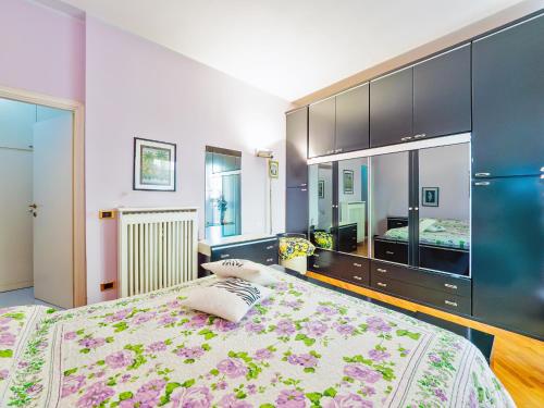 a bedroom with a large bed and a large closet at La Dolce vista, Lecco apartment with lake view in Malgrate