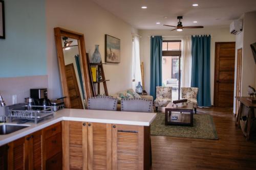 a living room with a kitchen and a living room with a couch at Ocean & Lighthouse view apartment in Playa Venao