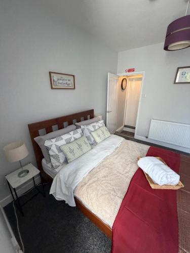a bedroom with a large bed and a red couch at Graham Road in Rugby