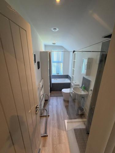 a bathroom with a shower and a toilet and a sink at Graham Road in Rugby