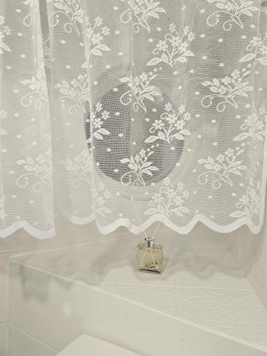 a bathroom with a shower curtain and a toilet at Busan Harbor Stay in Busan