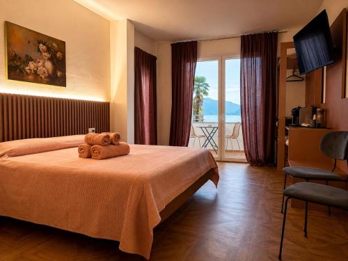 a hotel room with a bed with two teddy bears on it at B&B Belvedere in Colico