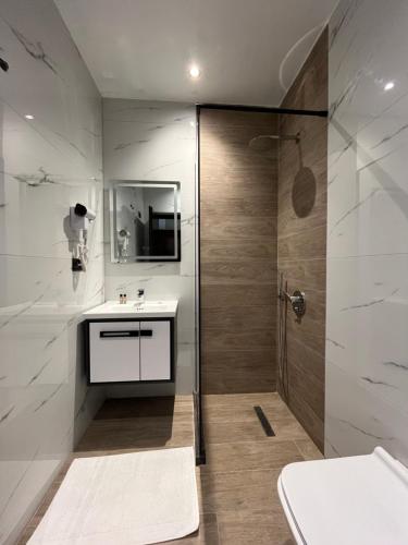 a bathroom with a shower and a sink at Mont Blanc Hotel in Peshkopi