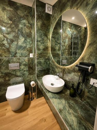 a bathroom with a sink and a mirror at B&B Belvedere in Colico