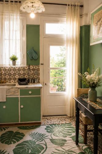 a kitchen with a door and a table and a window at Alexandra's house in Arta