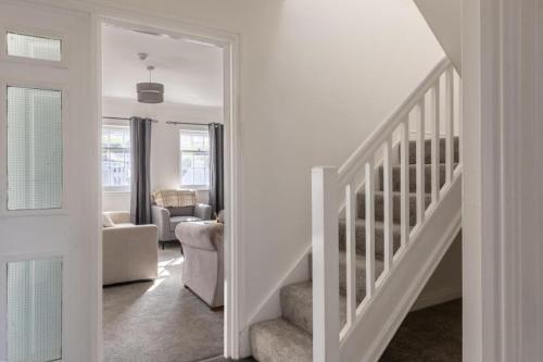 a white staircase in a room with a living room at Harbour View in Whitehaven