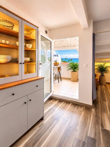 a kitchen with a view of the ocean at Ocean Eleven Boutique Stay - Sea View Sunset Terrace in Sainte-Anne