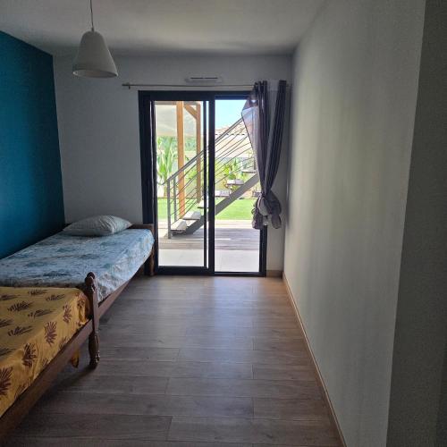 a bedroom with a bed and a sliding glass door at Villa View in Combaillaux