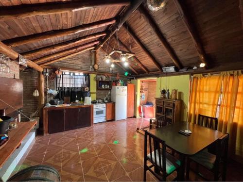 a large kitchen with a table and a kitchen with at El rancho in Parana