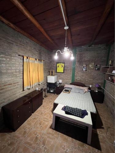 a bedroom with a bed with a keyboard on it at El rancho in Parana