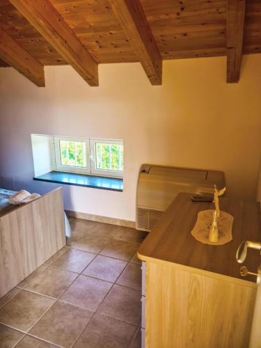 a kitchen with wooden ceilings and a counter top at La Casa del Cedro - Riposto in Riposto