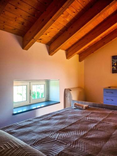 a bedroom with a bed and two windows at La Casa del Cedro - Riposto in Riposto