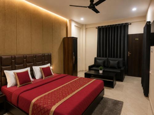 a bedroom with a large bed and a chair at Hotel Aria Bhopal Near AIIMS Hospital & Rani Kamlapati Station in Bhopal