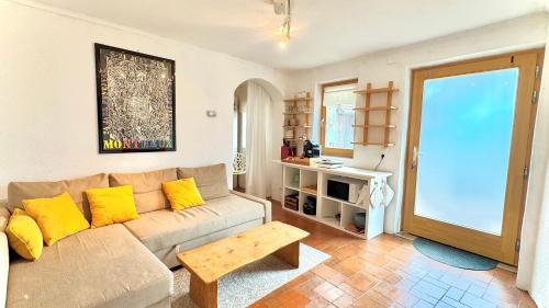 a living room with a couch and a table at Ferienhaus am Land in Mogersdorf