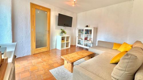 a living room with a couch and a table at Ferienhaus am Land in Mogersdorf