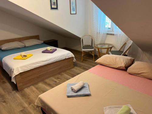 a bedroom with two beds with towels on them at Villa Miranda - Croazia in Omiš