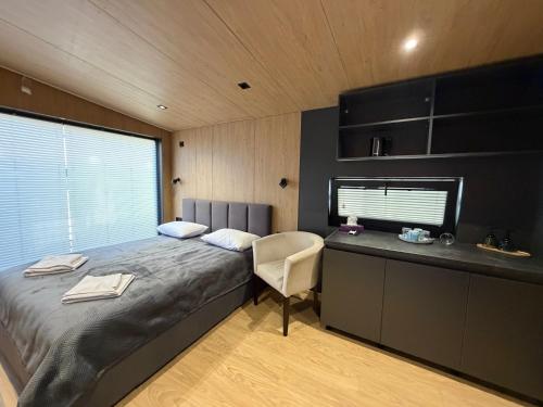 a bedroom with a bed and a desk and a chair at U Dominicana in Kamianets-Podilskyi