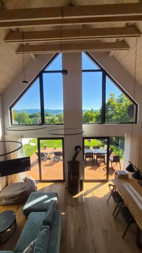 a living room with large windows and a couch at Chata Vista in Rožnov pod Radhoštěm