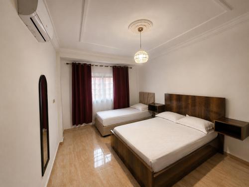 a bedroom with a bed and a couch in it at City zen oujda in Oujda
