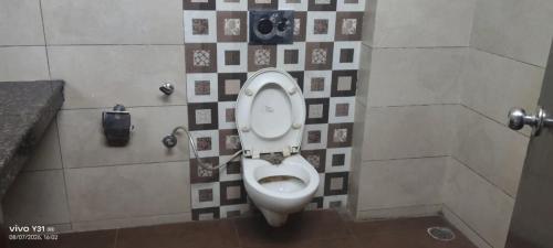 a bathroom with a toilet in a bathroom stall at 9 orchid Parbhat royal in Gobindgarh