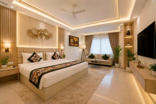 a bedroom with a large bed and a living room at Hotel Grand Suites Premier - Near Delhi Aerocity in New Delhi