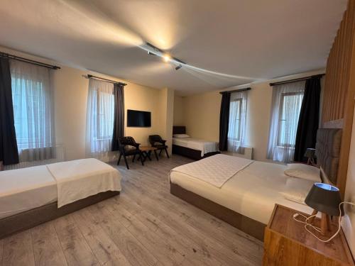 a hotel room with two beds and a desk at Grand 464 Otel in Rize