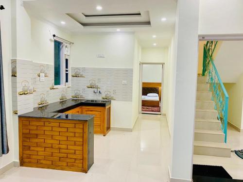 a large bathroom with a sink and a staircase at Jagatram Niwas Guesthouse Dharamkot in Dharamshala