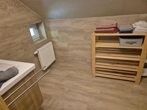 a small bathroom with a sink and a shelf at Appartment Haus Zirknitz in Mitterzirknitz