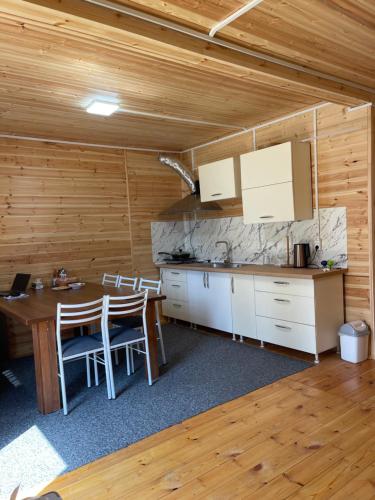 a kitchen and dining room with a table and chairs at Adam in Chon-Sary-Oy