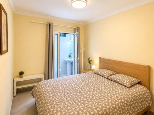 a bedroom with a large bed and a bathroom at Roca Playa Mogan in Puerto de Mogán