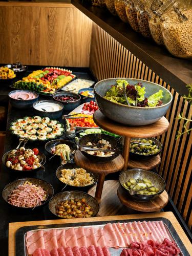 a table with a bunch of different types of food at Maiers Hotel in Bayerisch Eisenstein