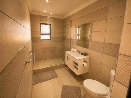 a bathroom with a toilet and a sink at On Appointment at the Sea in Wilderness