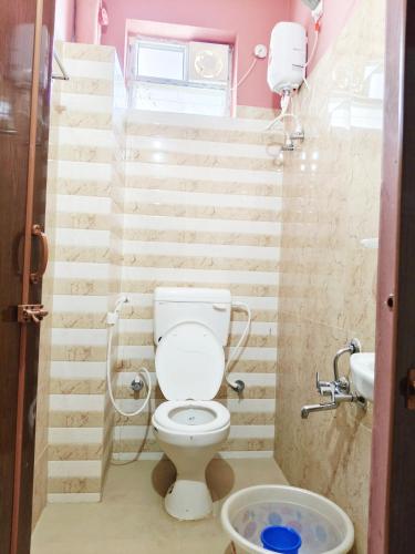 a small bathroom with a toilet and stairs at Hotel Jyothi Kumar Royal ac rooms in Srikalahasti