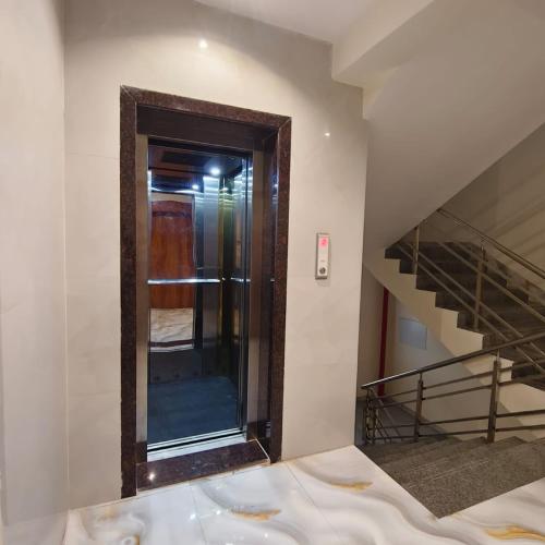 a mirror in a room with a staircase at Marina Executive Rooms in Navi Mumbai