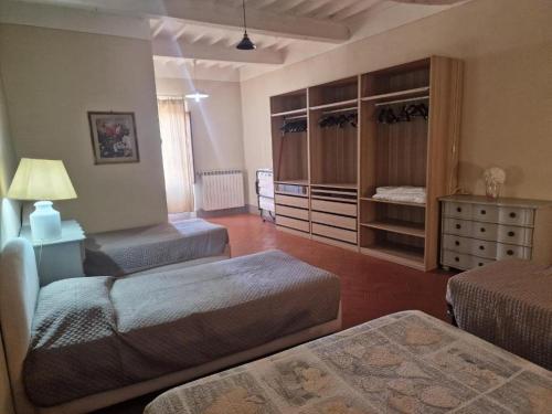 a large room with two beds and a dresser at Attico le due Torri in Arezzo