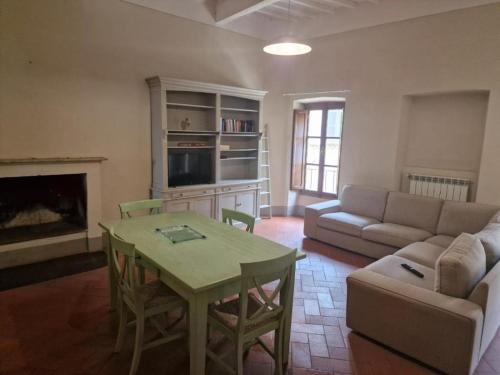 a living room with a couch and a table and a couch at Attico le due Torri in Arezzo