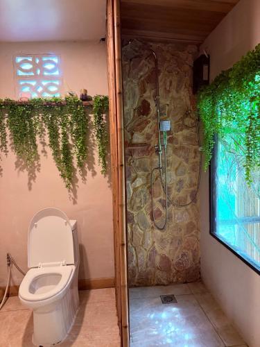 a bathroom with a toilet and a shower at Star Fish Cozy House in Ban Nua