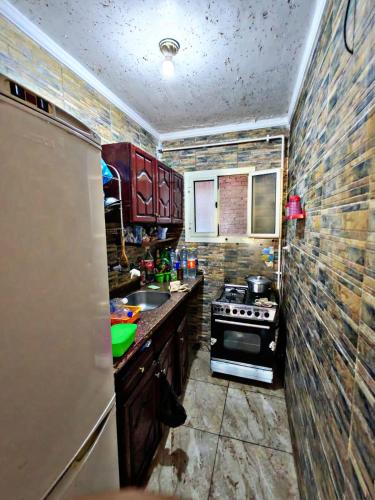 a kitchen with a sink and a stove in it at لؤلؤة البحر in Alexandria