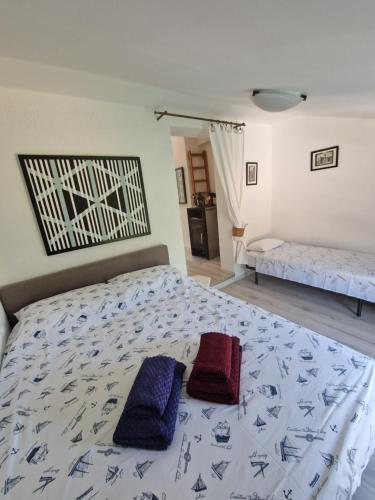 a bedroom with a bed with two pillows on it at Art Gallery suite in Vantačići