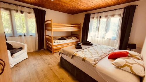 a bedroom with two beds and a bunk bed at CHATA POD HORAMA in Benecko