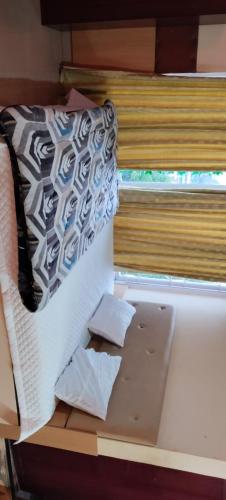 a bed with two pieces of paper laying on it at Friends cottage in Coonoor