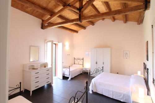 a bedroom with a bed and a dresser in a room at Reusia Holiday Home in Ragusa