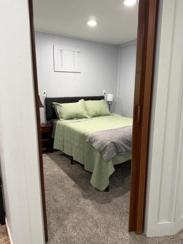 a bedroom with a bed with a green bedspread at Canton River House in Canton