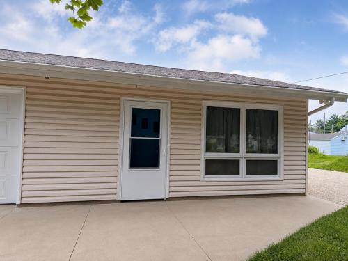 a small house with a white door and windows at Canton River House in Canton
