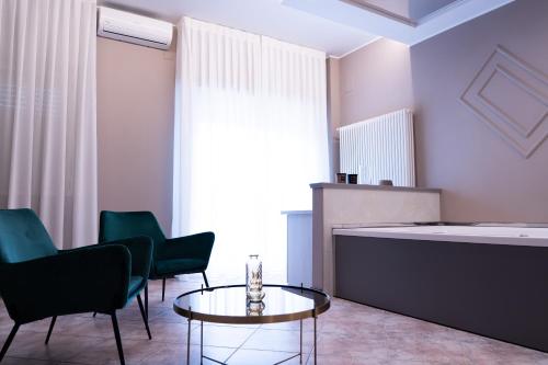 a living room with two chairs and a table at Residence Hotel Azzurro in LʼAquila