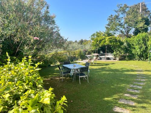 a table and chairs in the grass in a yard at Maison Margherita in Calmasino